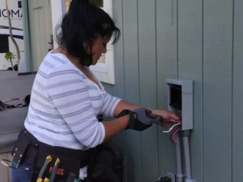 Licensed electrician wiring an exterior subpanel in Experiment