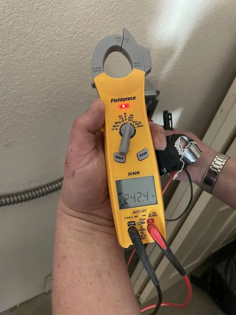 Voltage testing with clamp meter during Recessed Lighting Installation in Experiment